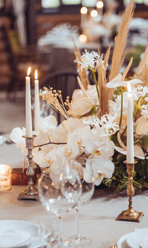 A table with flowers and candles on it