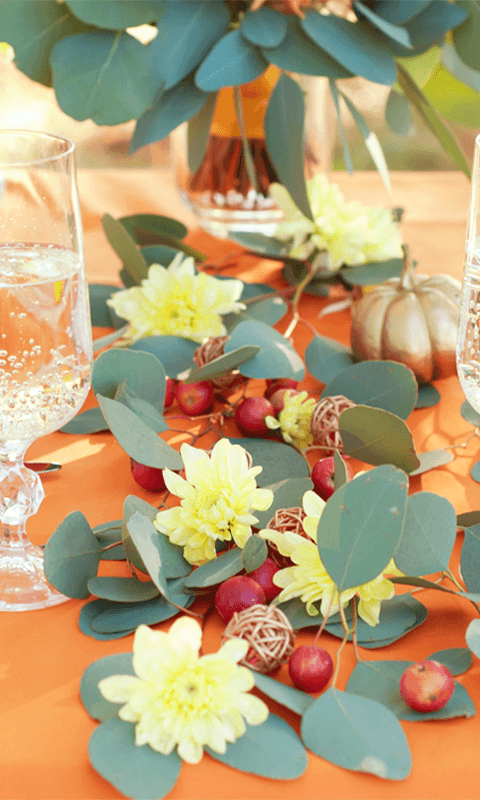 A table with some leaves and flowers on it
